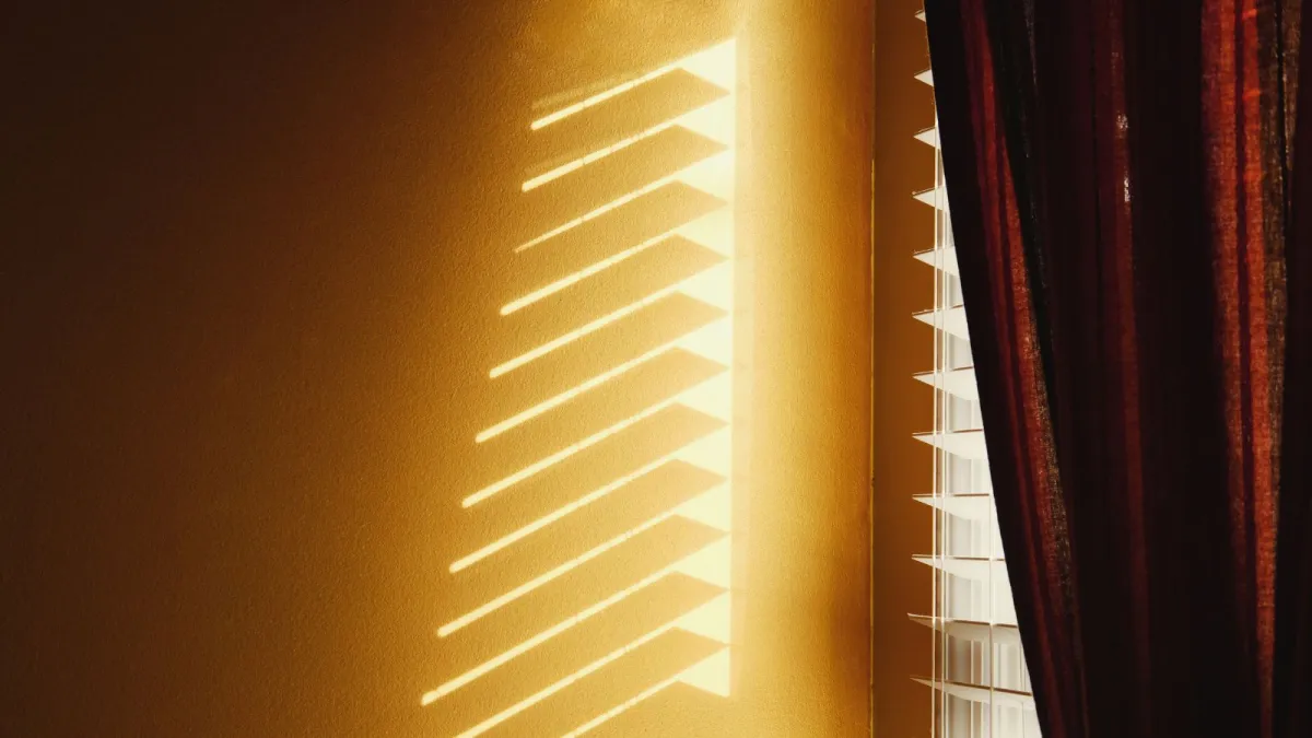 sun-coming-in-through-blinds-saving-money-working-from-home